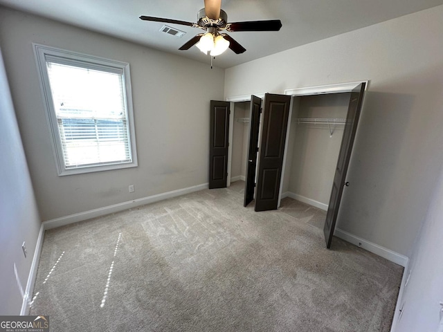 unfurnished bedroom featuring light carpet and ceiling fan