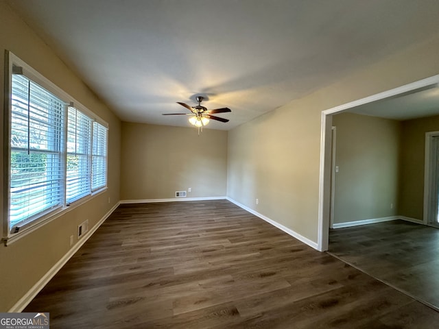 unfurnished room with dark hardwood / wood-style floors and ceiling fan