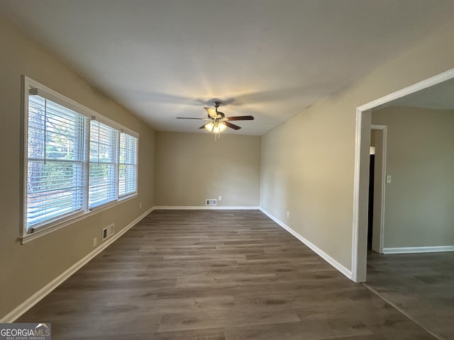 1581 Hollyhock Ter, Decatur, GA 30032 - empty room with a ceiling fan, dark wood-style floors, and baseboards