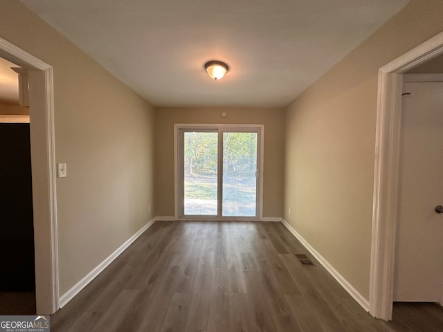 empty room with dark hardwood / wood-style floors