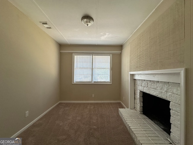 unfurnished living room with a stone fireplace and carpet