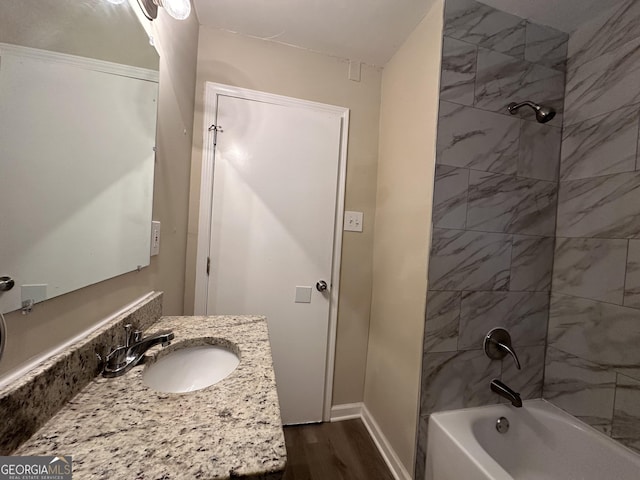1581 Hollyhock Ter, Decatur, GA 30032 - bathroom with wood finished floors, shower / bath combination, vanity, and baseboards