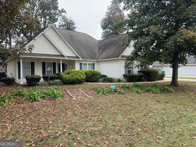 view of front of property featuring central AC unit and a front yard