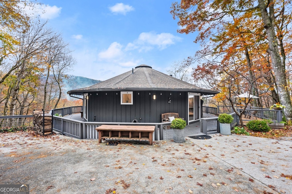 rear view of property featuring a mountain view