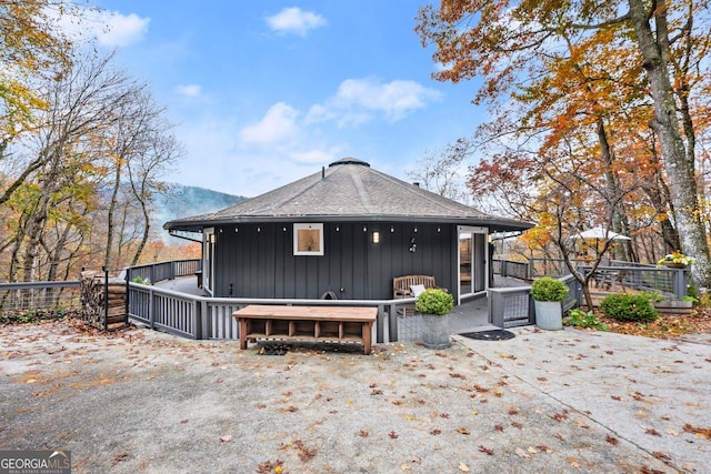 rear view of property featuring a mountain view