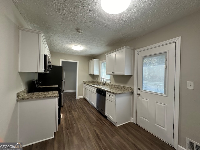 kitchen featuring stainless steel appliances, dark hardwood / wood-style flooring, a textured ceiling, sink, and white cabinetry