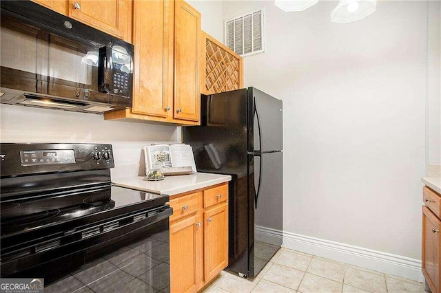 kitchen with black appliances and light tile patterned floors