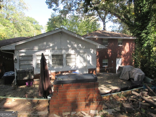 back of property featuring a deck