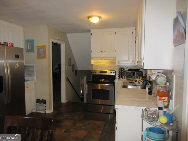 kitchen featuring stainless steel appliances, white cabinets, sink, and backsplash