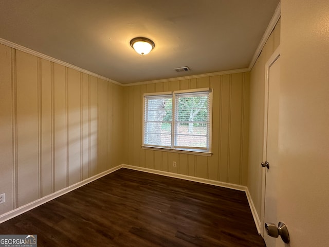 unfurnished room with dark wood-type flooring and ornamental molding