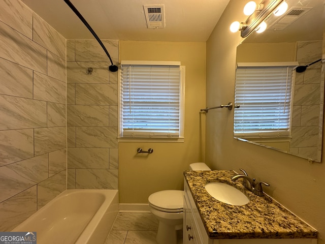 full bathroom featuring tile patterned floors, vanity, tiled shower / bath combo, and toilet