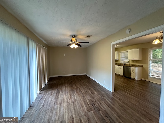 unfurnished living room featuring sink, ceiling fan, a textured ceiling, and dark hardwood / wood-style floors