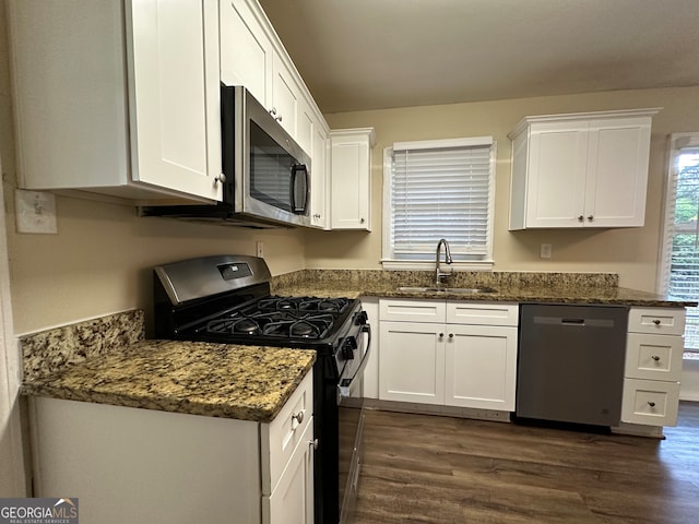 kitchen featuring stainless steel appliances, white cabinets, sink, and dark hardwood / wood-style flooring