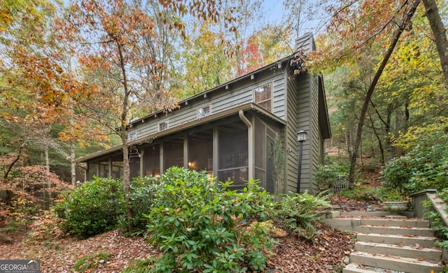 view of side of home featuring a sunroom