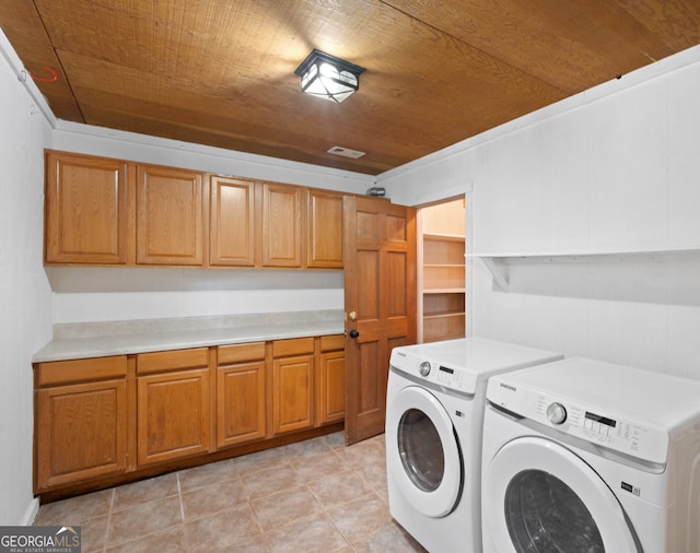 washroom with washing machine and dryer, cabinets, wood ceiling, and light tile patterned flooring