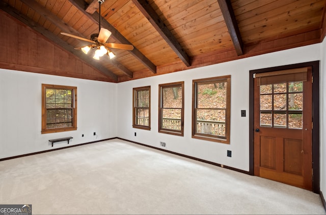 interior space featuring beamed ceiling, light colored carpet, and a healthy amount of sunlight