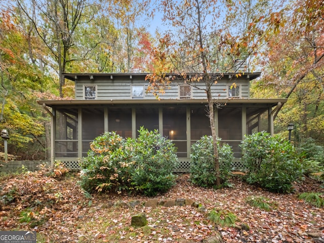 back of house with a sunroom