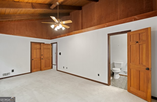 unfurnished bedroom with vaulted ceiling with beams, wood ceiling, light carpet, connected bathroom, and ceiling fan