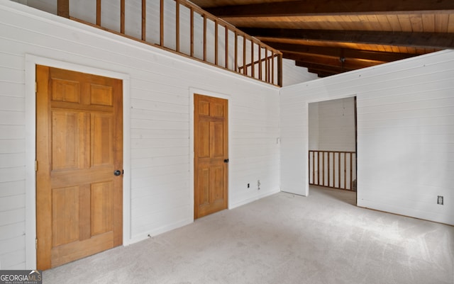 interior space with wooden ceiling, beam ceiling, wooden walls, and high vaulted ceiling