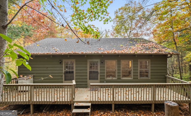 rear view of property featuring a deck