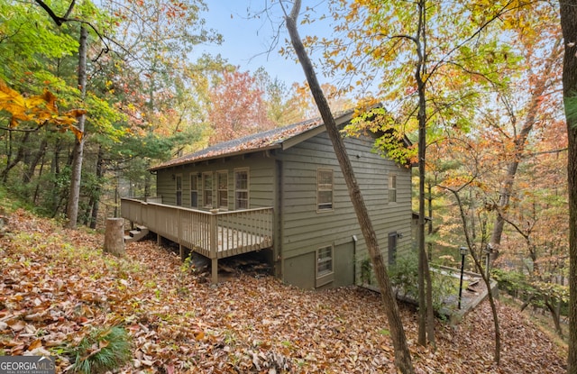 view of side of property with a wooden deck