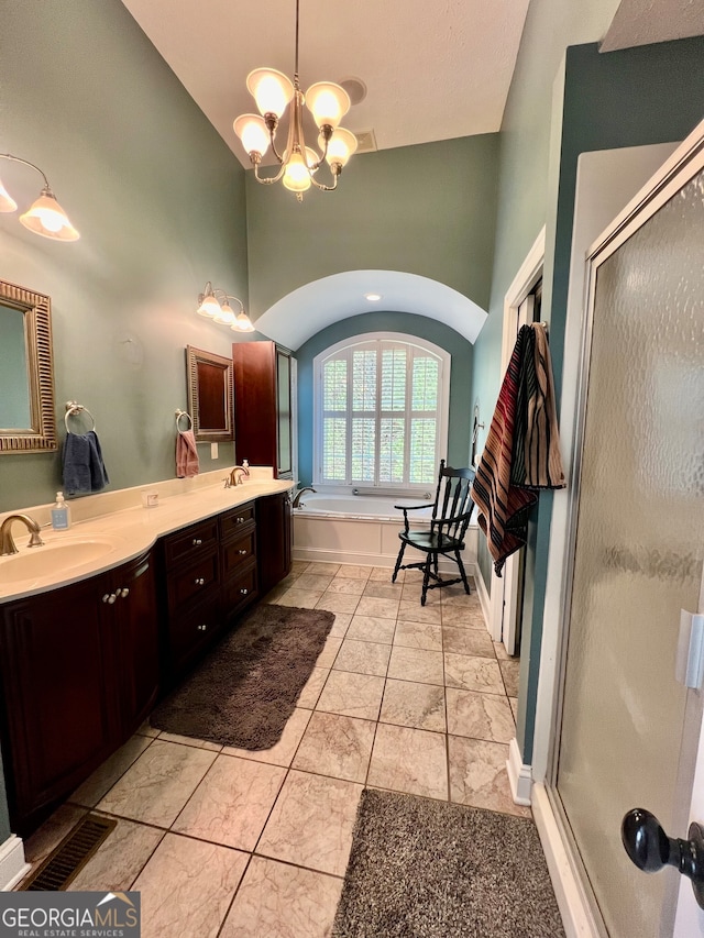 bathroom with a notable chandelier, shower with separate bathtub, lofted ceiling, and vanity