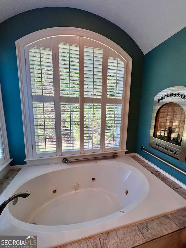 bathroom featuring tiled tub