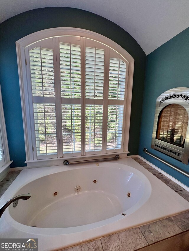 bedroom with ceiling fan, dark hardwood / wood-style floors, and vaulted ceiling