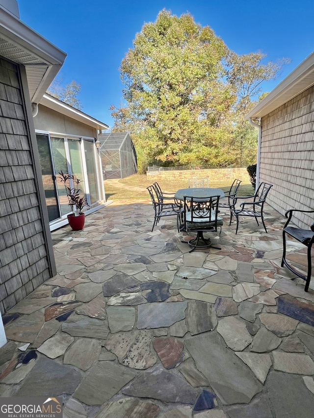 view of patio featuring a storage shed