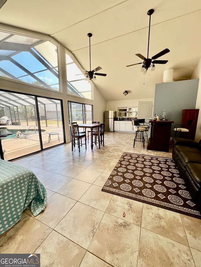 living room featuring high vaulted ceiling, light tile patterned floors, and ceiling fan