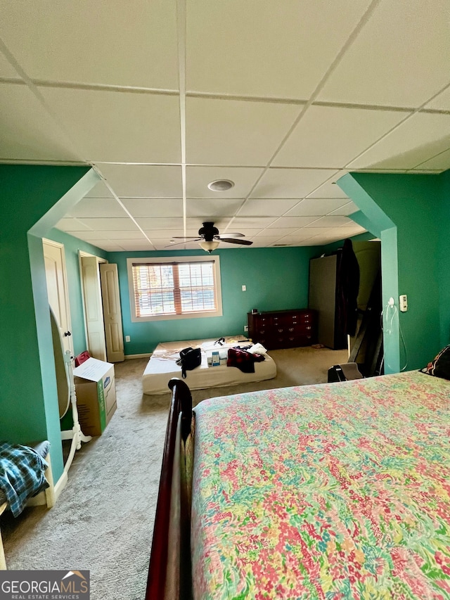 carpeted bedroom with a drop ceiling