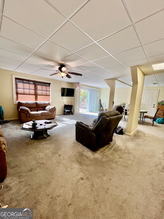 carpeted living room featuring a drop ceiling and ceiling fan