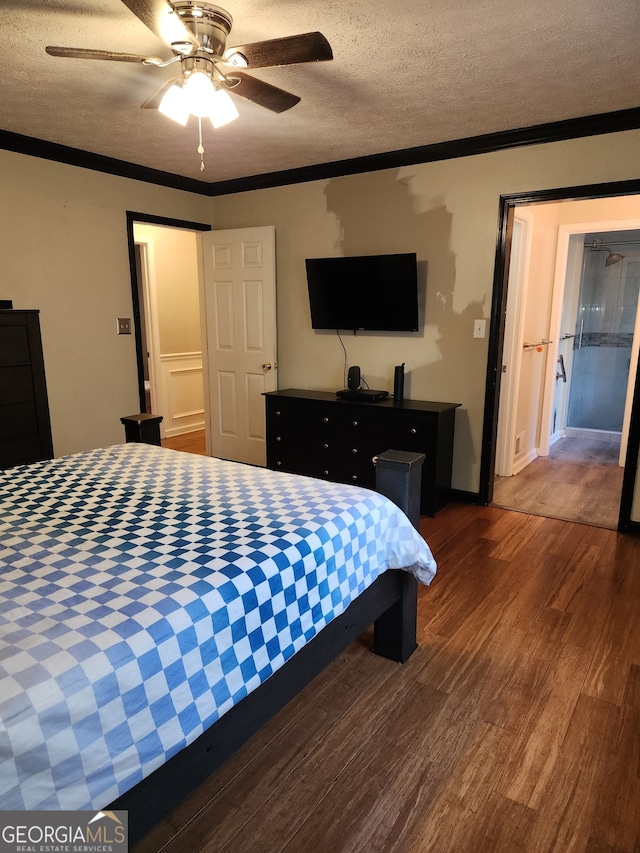 bedroom featuring a textured ceiling, dark hardwood / wood-style floors, ceiling fan, and ornamental molding