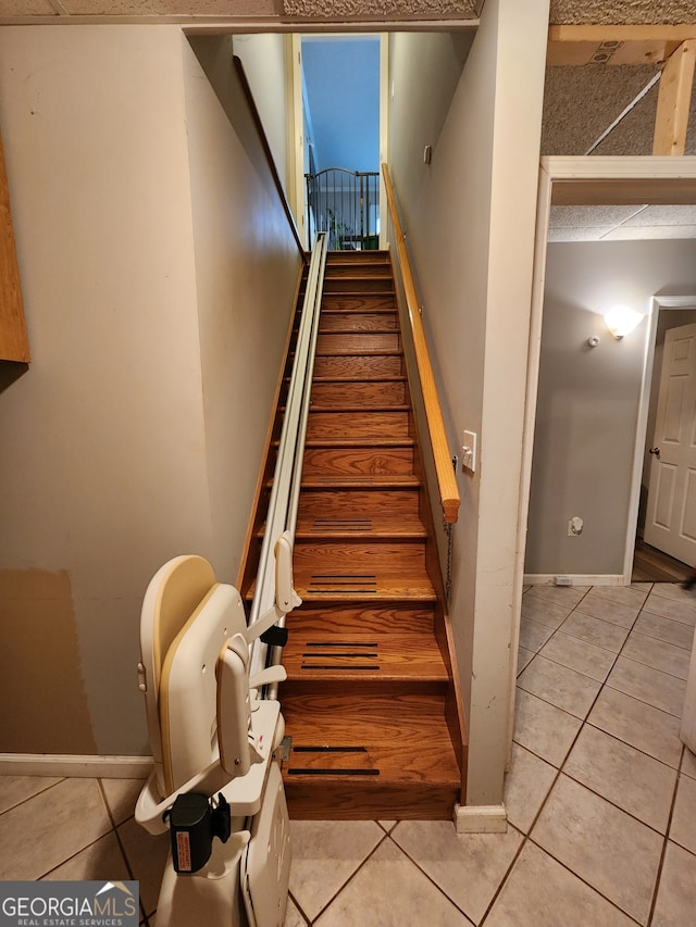 staircase with tile patterned floors