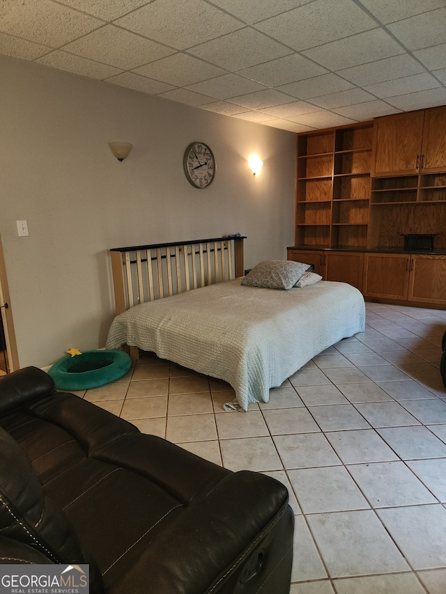 tiled bedroom with a paneled ceiling