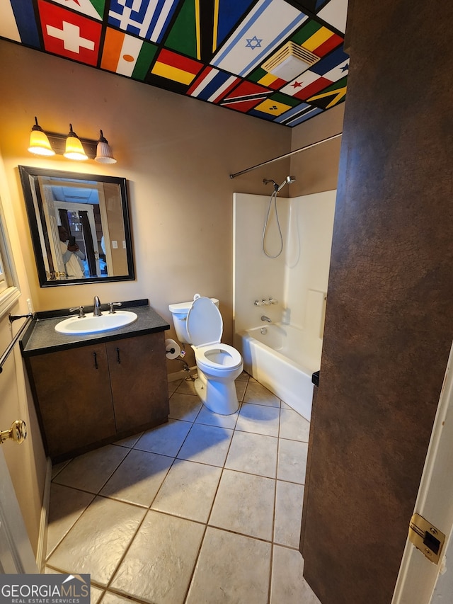 full bathroom with tile patterned flooring, vanity, bathing tub / shower combination, and toilet