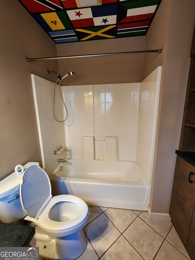 bathroom with tile patterned flooring, toilet, and tub / shower combination