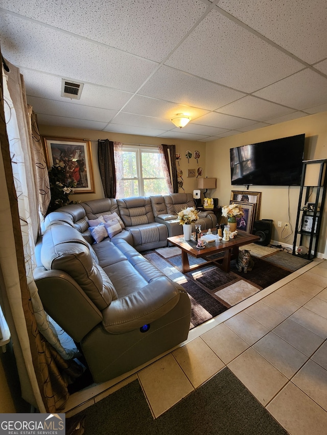 tiled living room with a paneled ceiling