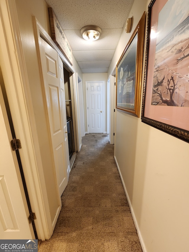 hallway featuring dark carpet