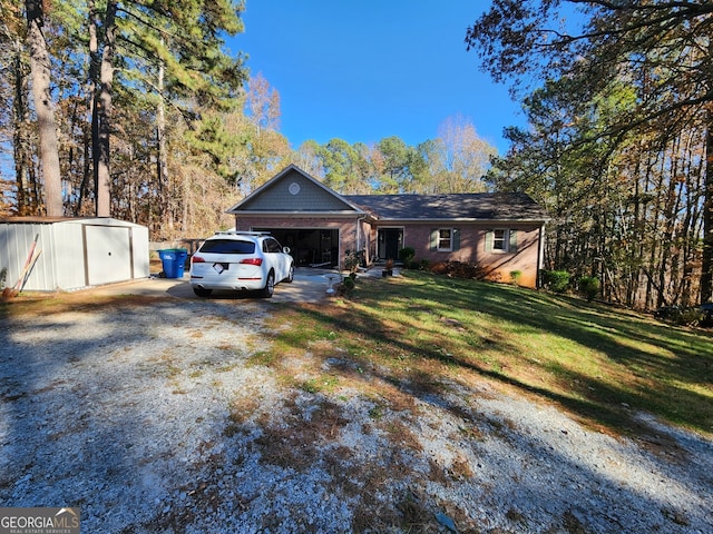 ranch-style home featuring a front yard, a garage, and a storage shed