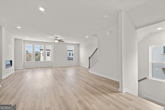 unfurnished living room with ceiling fan and light hardwood / wood-style floors