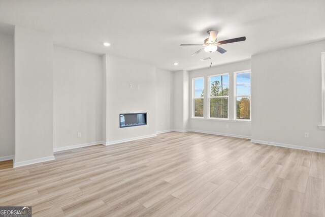 unfurnished living room with light hardwood / wood-style floors and ceiling fan