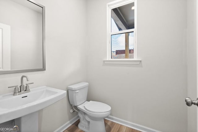 bathroom featuring hardwood / wood-style flooring, toilet, and sink