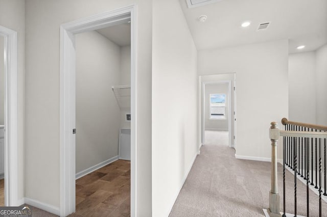 hallway with light colored carpet