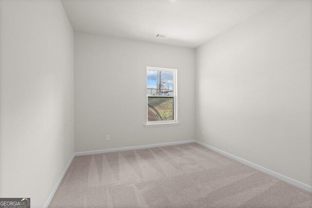 empty room with light colored carpet