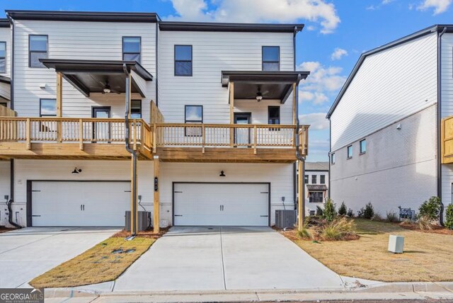 view of front of house with a balcony, a garage, ceiling fan, and central air condition unit