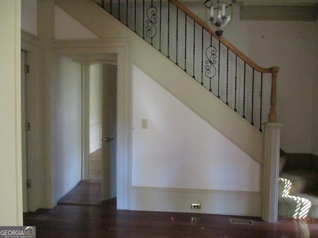 stairs featuring a notable chandelier