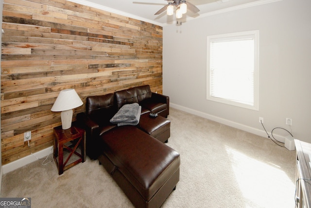 living area featuring wood walls, ornamental molding, and light carpet