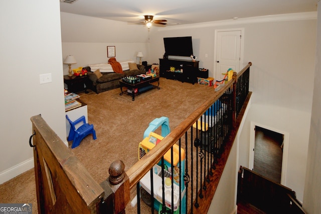 carpeted living room featuring ceiling fan, lofted ceiling, and ornamental molding