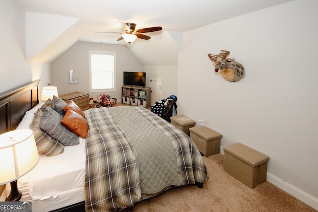 carpeted bedroom with ceiling fan and vaulted ceiling